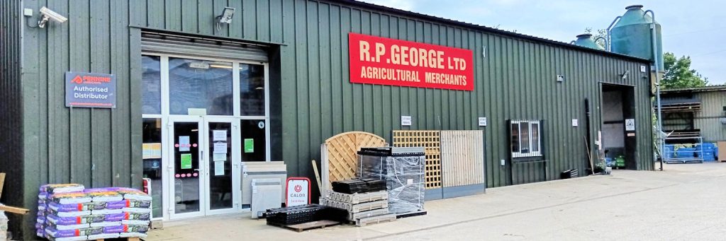 A green exterior showcases an agricultural supply and hardware store in Uttoxeter, "R.P. George Ltd," with a sign. Various items are displayed outside, including animal feed, wooden fences, and other supplies.