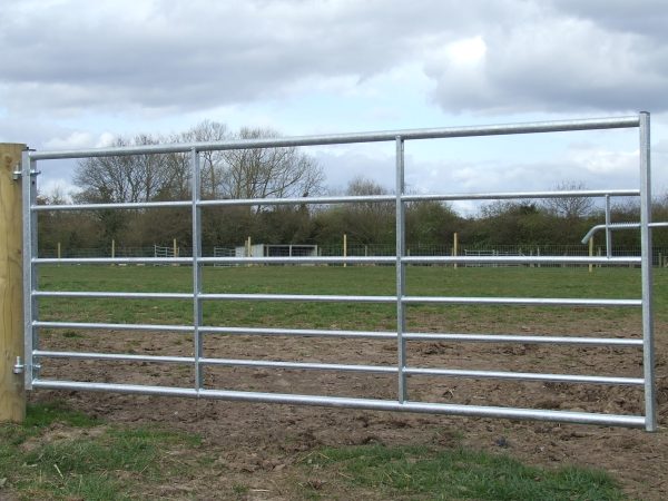 A steel field gate in front of a field