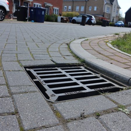 A grid fixed into a road on a housing estate.