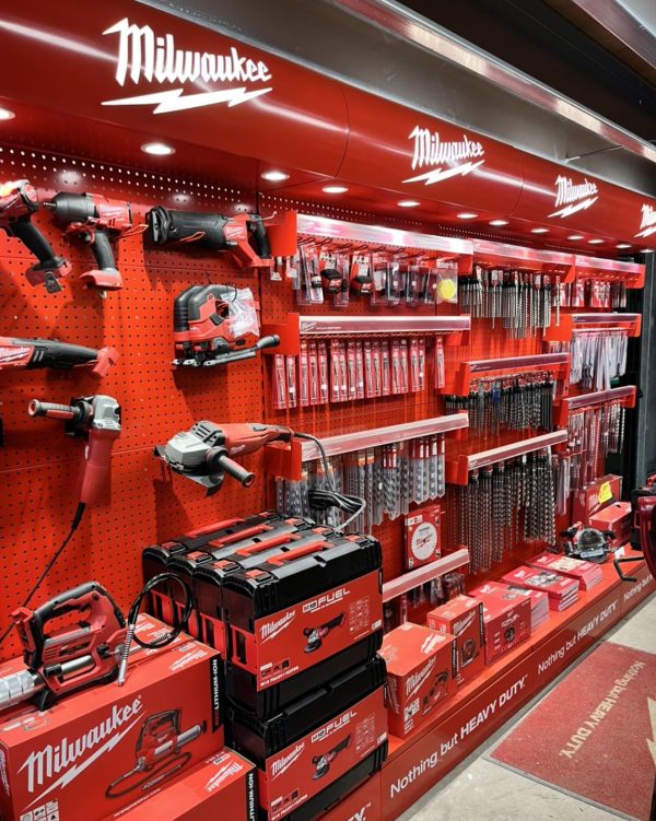 The red, illuminated Milwaukee stand displaying a variety of tools inside RP George.