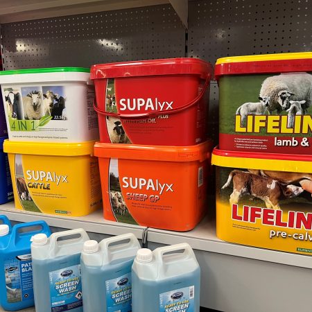 A shelf containing a display of livestock mineral buckets.