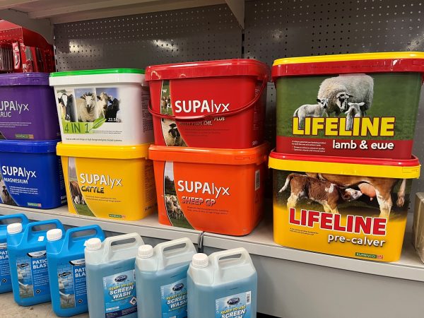 A shelf containing a display of livestock mineral buckets.