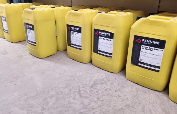 A row of 25-litre yellow containers of oil by Pennine Lubricants.