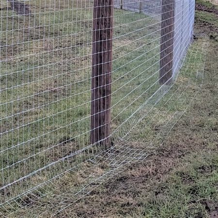 A wire fence designed to prevent otters from being able to get through.